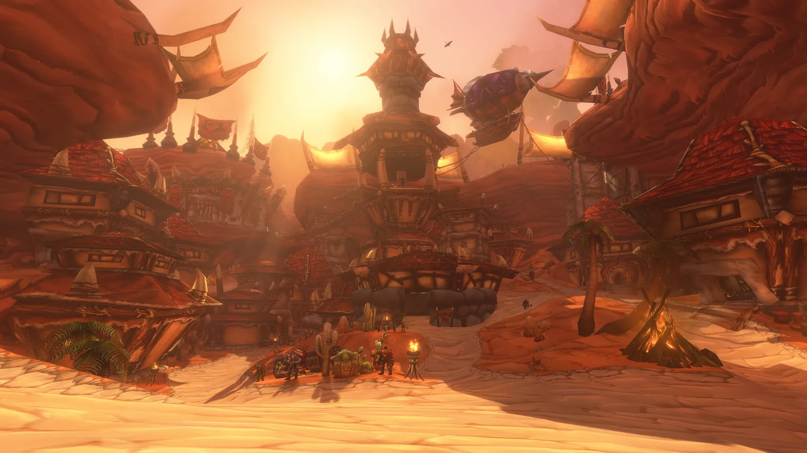 A Horde city of red rock and spiked towers at sunset, with a zeppelin overhead
